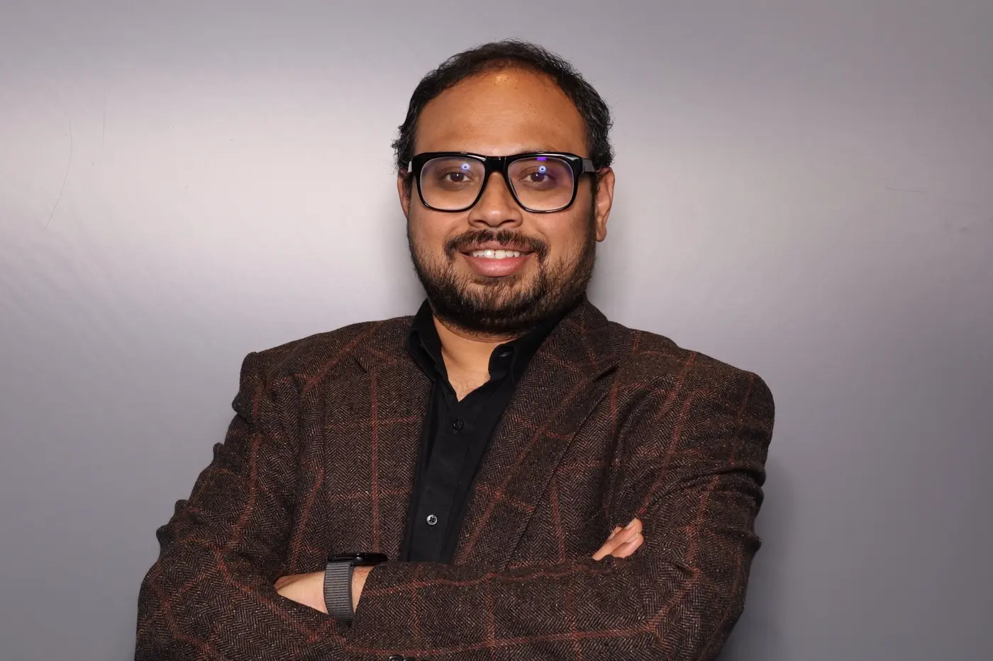 Siva Sadhu in a brown checked jacket